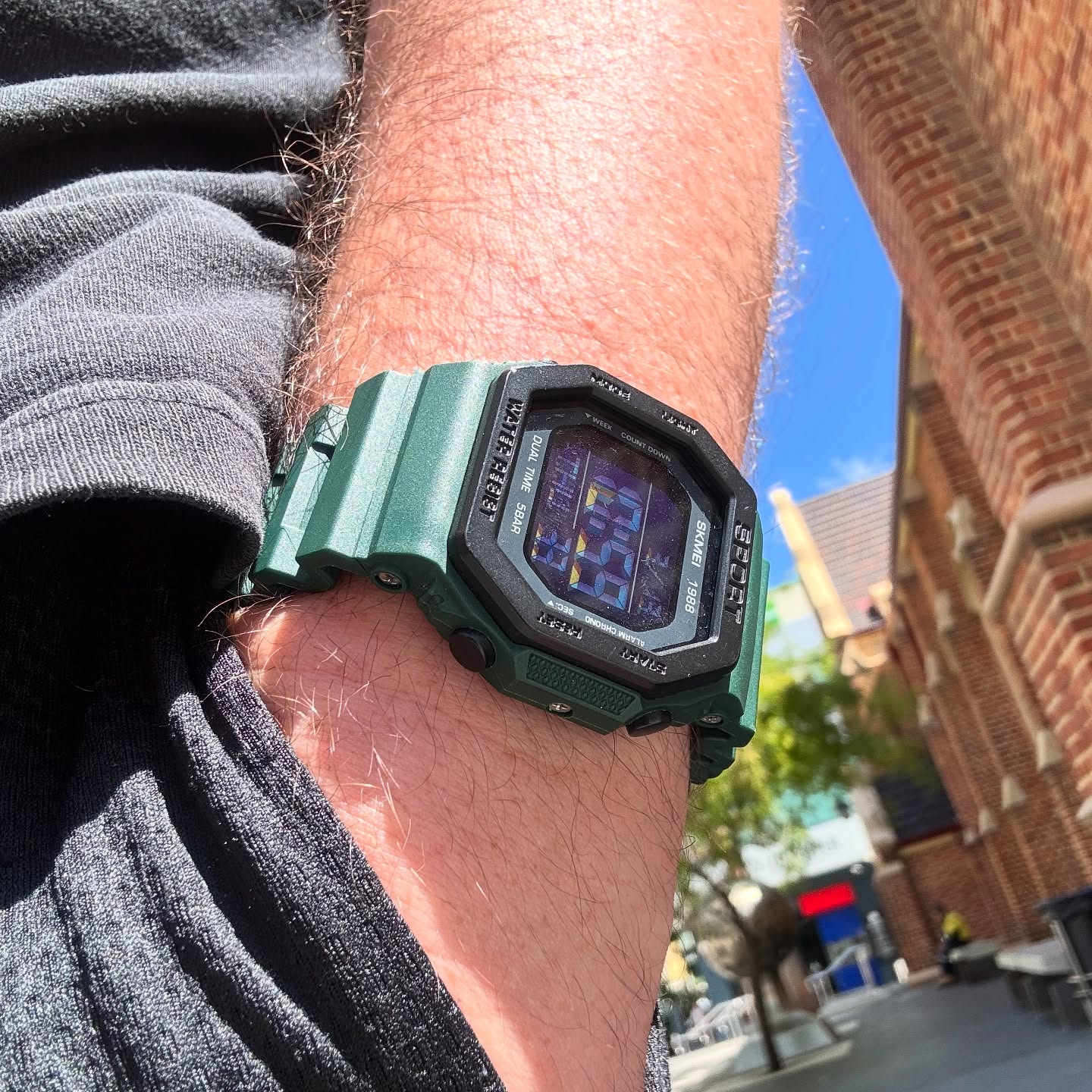 Army-green SKMEI 1988 worn outdoors on wrist