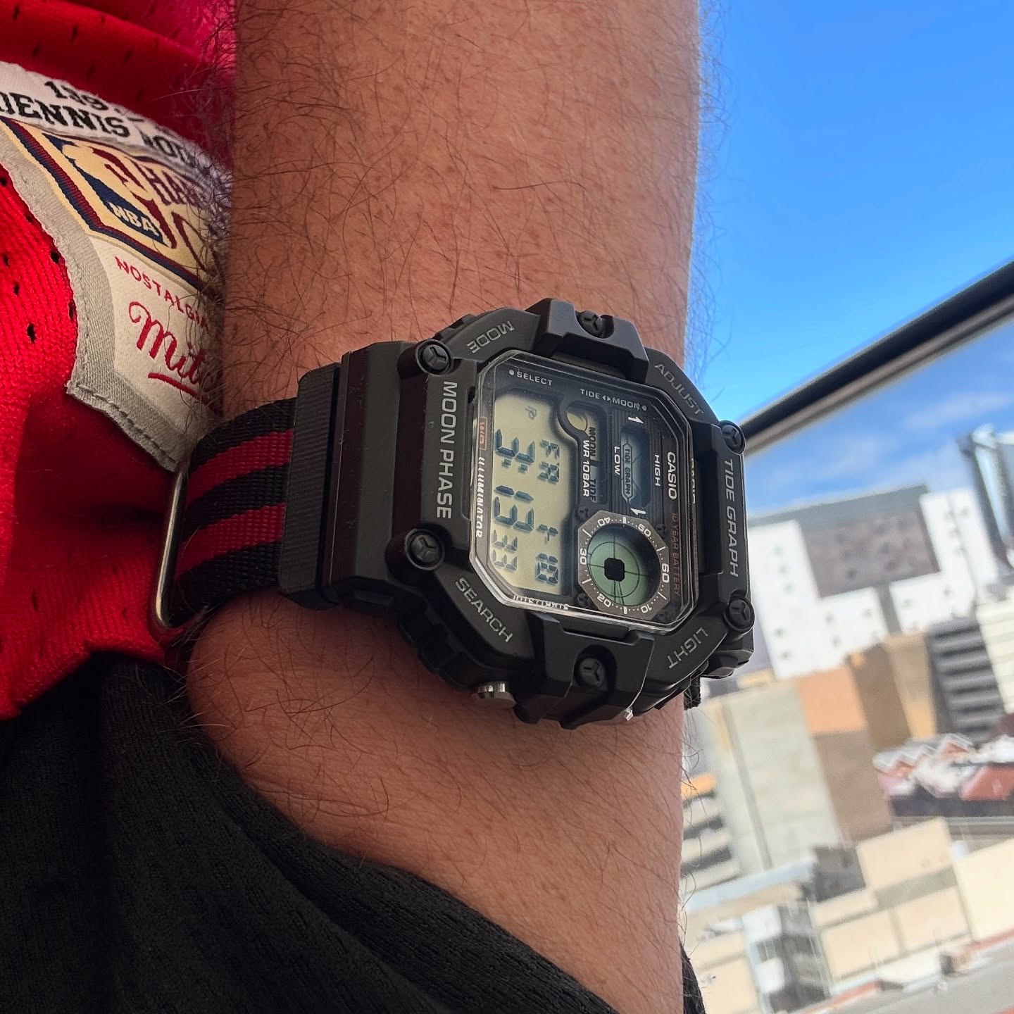 Casio WS-1700H fitted to a black-and-red NATO strap and worn outdoors